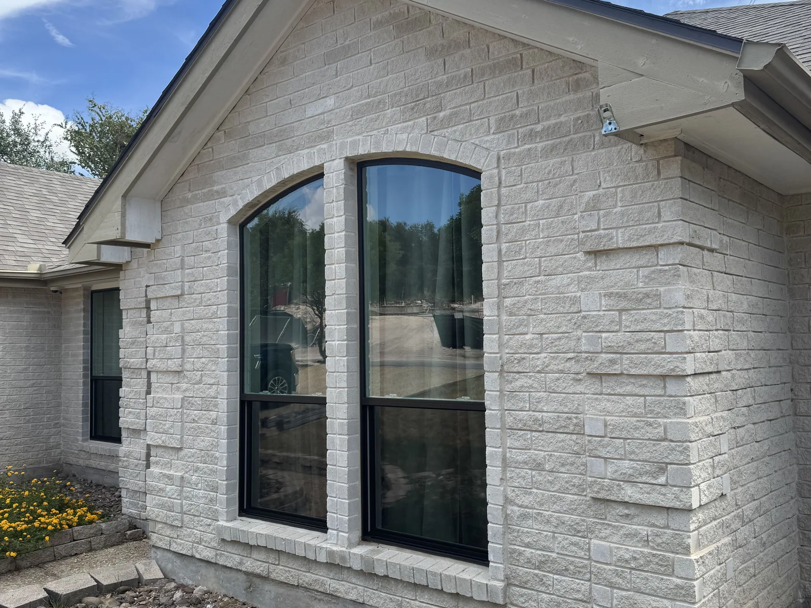 Clean arched windows on a limestone home after a window cleaning