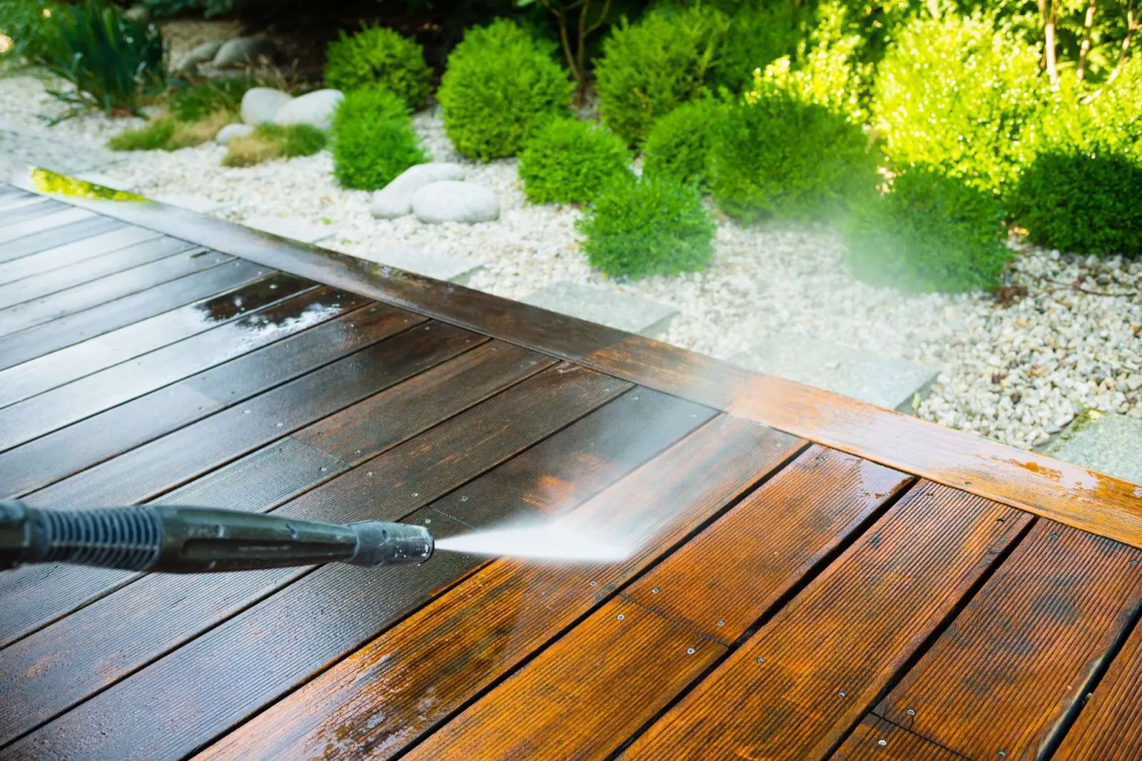 Spray wand cleaning weathered wood deck boards