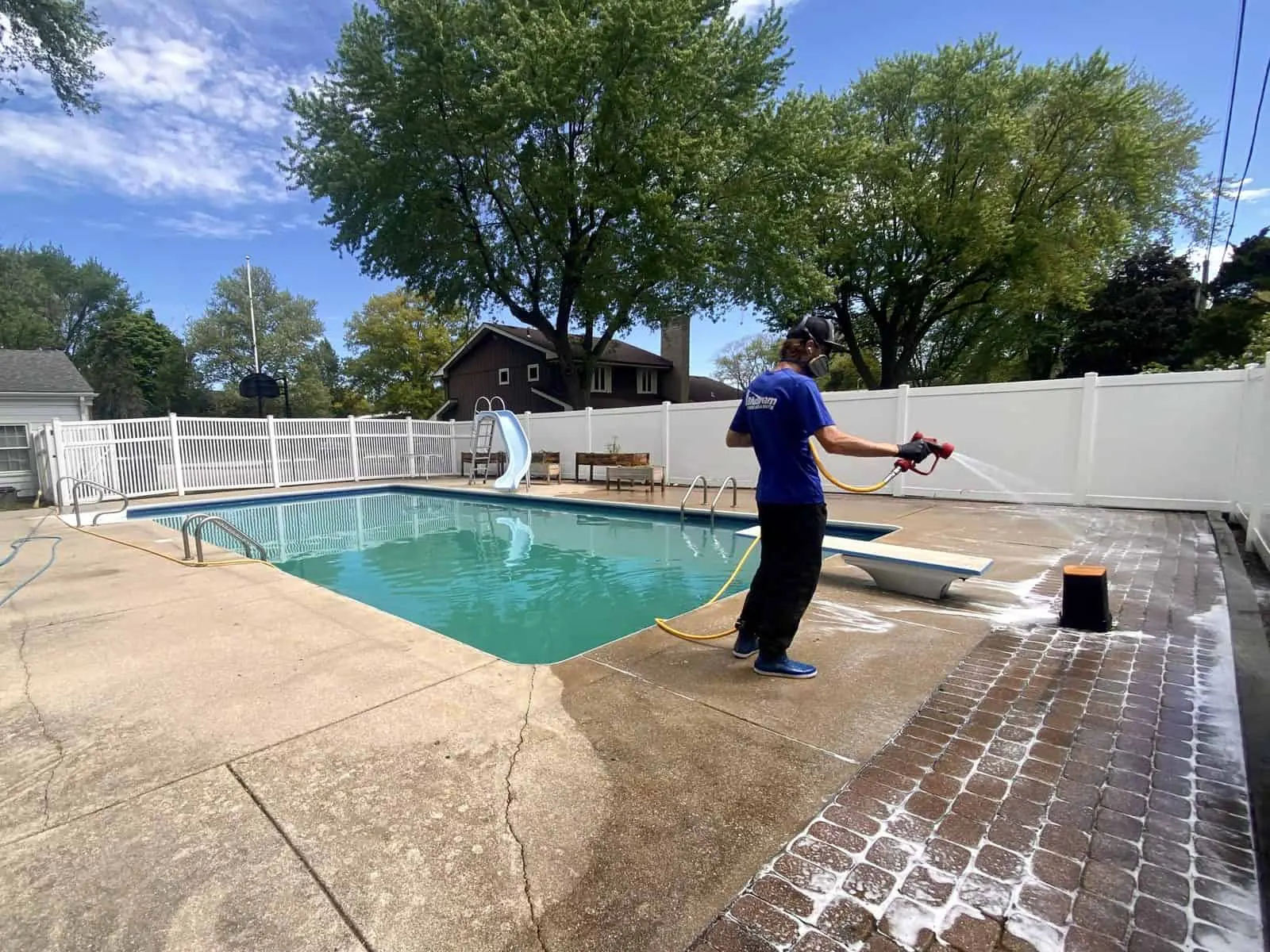 Paver patio being pressure washed at a home