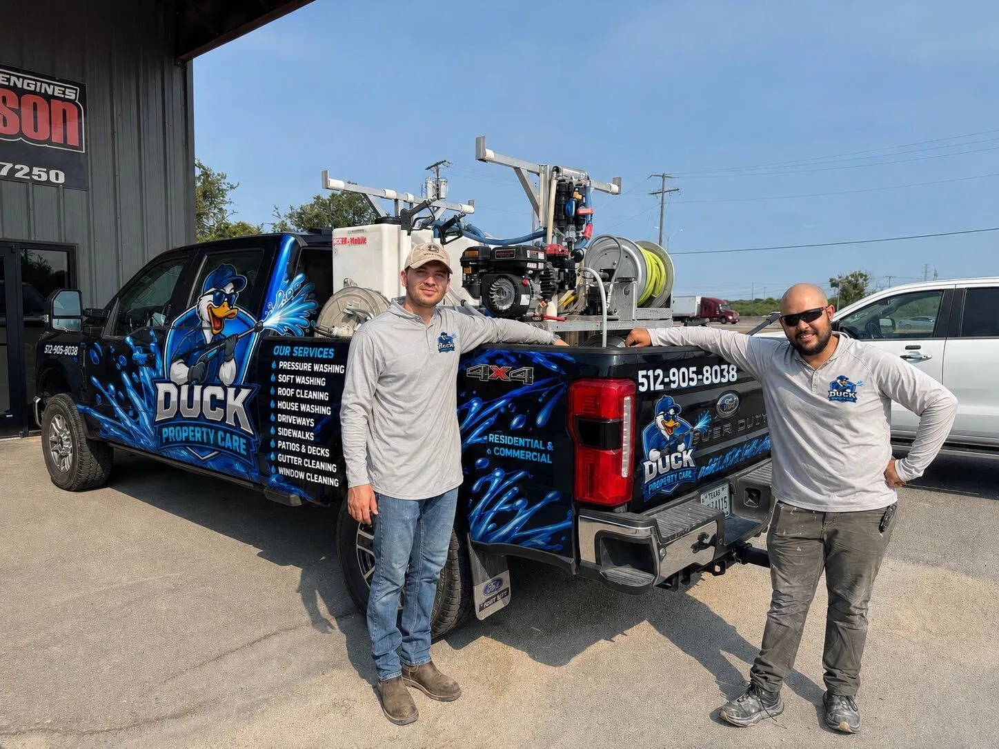 Duck Property Care crew with the company's wrapped pressure washing truck and rig in San Antonio, TX