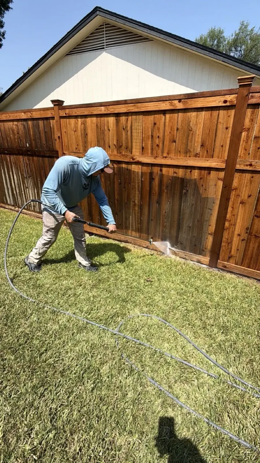 Low pressure rinse bringing back the color of a wood fence near San Antonio